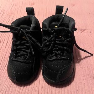 Black Baby Jordan 12 size 5C, used but in good condition only worn 3 times
